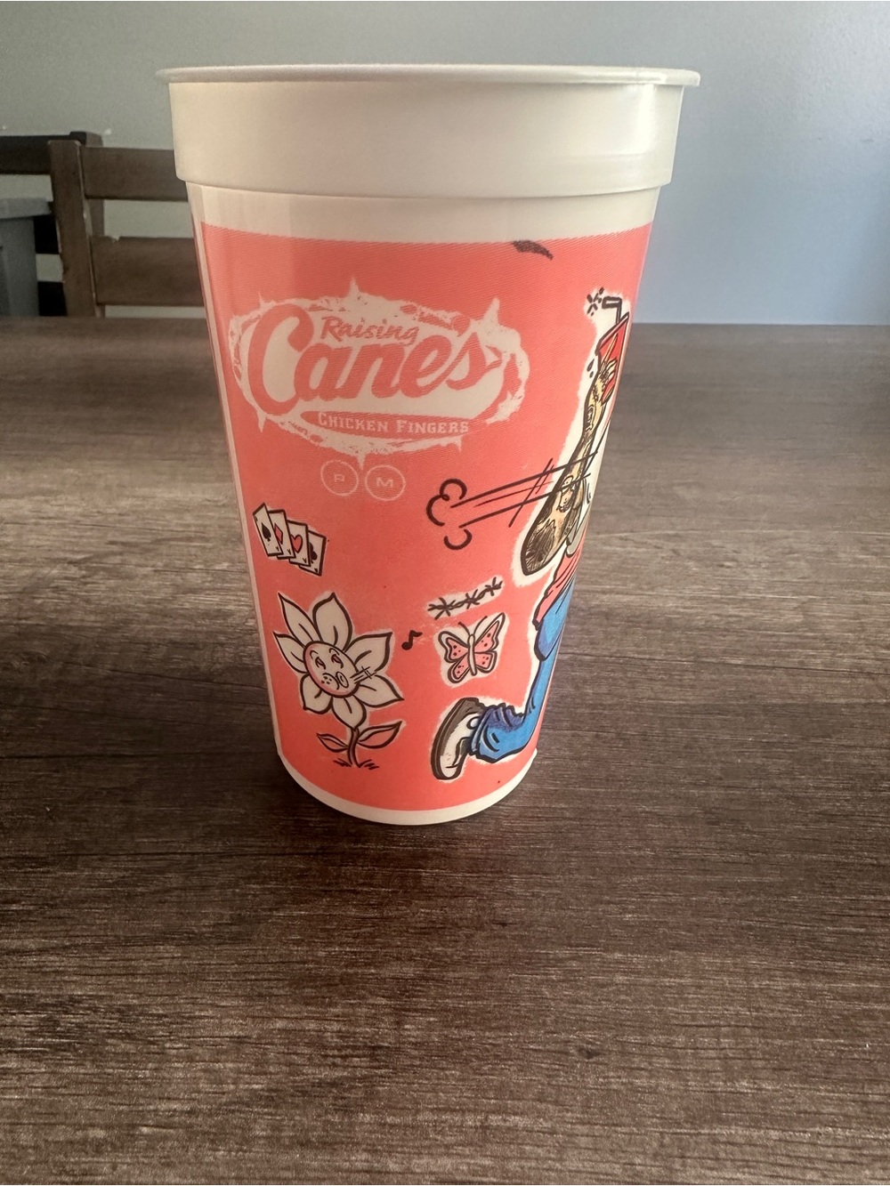 Raising Cane's pink cup with Post Malone and text #raisingcanes #fastfood